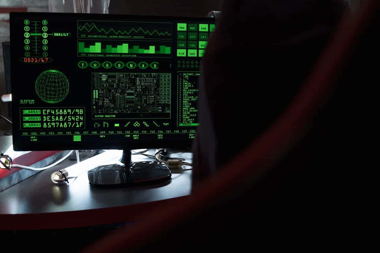 View of a computer monitor displaying green digital security code in an indoor setting.